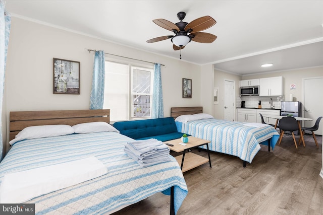 1004 Philadelphia Ave, Ocean City, MD 21842 - bedroom with ornamental molding, light wood-type flooring, a sink, a ceiling fan, and recessed lighting