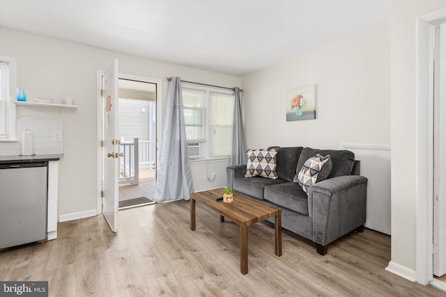 1004 Philadelphia Ave, Ocean City, MD 21842 - living area with light wood finished floors, cooling unit, and baseboards