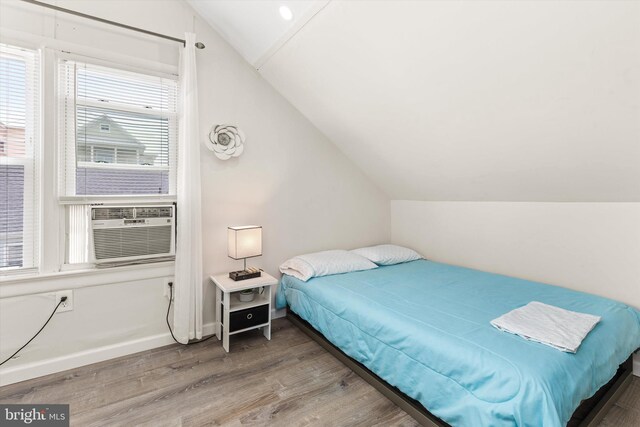 1004 Philadelphia Ave, Ocean City, MD 21842 - bedroom featuring vaulted ceiling, wood finished floors, multiple windows, baseboards, and cooling unit