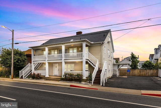 1004 Philadelphia Ave, Ocean City, MD 21842 - view of front of home with a porch, stairs, driveway, a chimney, and fence