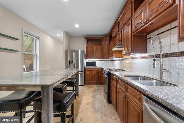 kitchen featuring appliances with stainless steel finishes, open shelves, a sink, under cabinet range hood, and decorative backsplash
