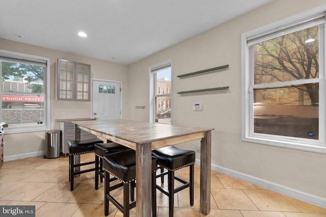 dining room with baseboards, plenty of natural light, light tile patterned floors, and recessed lighting