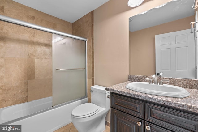 full bathroom with toilet, vanity, shower / bath combination with glass door, and tile patterned floors