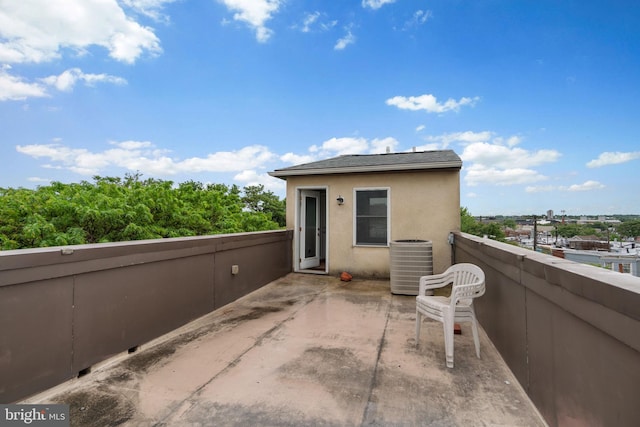 rear view of property with central AC, stucco siding, and a balcony