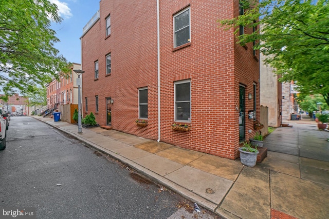 view of side of home with brick siding