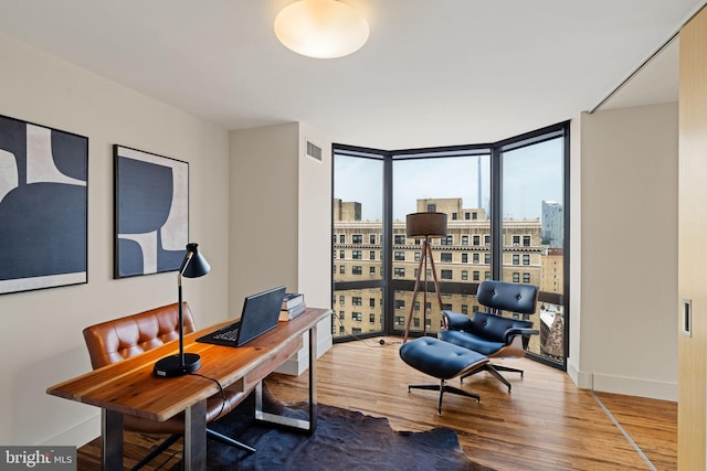 2018 Walnut St Unit 19Gh, Philadelphia, PA 19103 - home office featuring expansive windows, wood finished floors, a city view, and baseboards