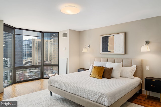 2018 Walnut St Unit 19Gh, Philadelphia, PA 19103 - bedroom with floor to ceiling windows, wood finished floors, and multiple windows