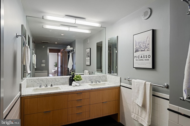 2018 Walnut St Unit 19Gh, Philadelphia, PA 19103 - bathroom with double vanity, wainscoting, and tile walls