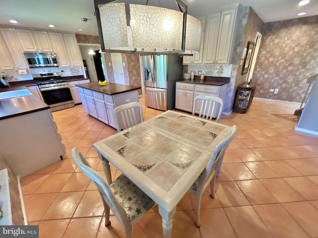 52 Dalton Way, Southampton, PA 18966 - kitchen featuring stainless steel appliances, dark countertops, wallpapered walls, light tile patterned flooring, and recessed lighting