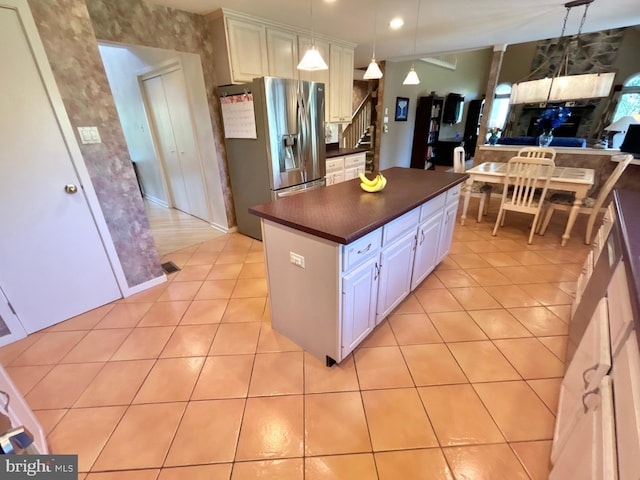 52 Dalton Way, Southampton, PA 18966 - kitchen featuring stainless steel refrigerator with ice dispenser, dark countertops, light tile patterned floors, a kitchen island, and white cabinetry