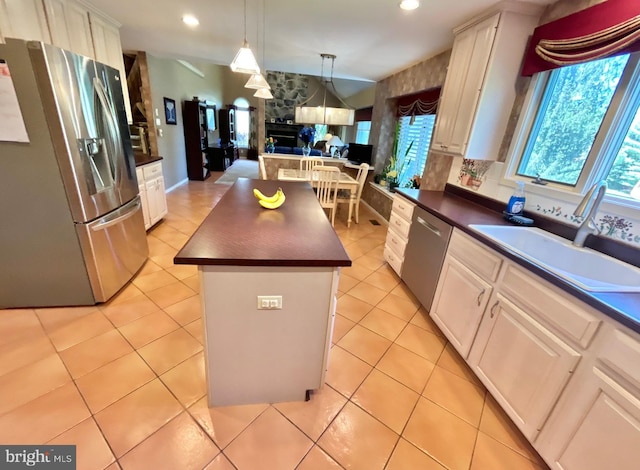 52 Dalton Way, Southampton, PA 18966 - kitchen with appliances with stainless steel finishes, a sink, dark countertops, a center island, and white cabinetry