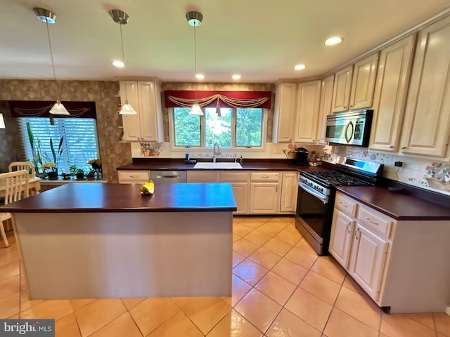 52 Dalton Way, Southampton, PA 18966 - kitchen featuring appliances with stainless steel finishes, a sink, dark countertops, light tile patterned flooring, and a kitchen island