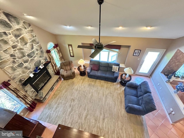 52 Dalton Way, Southampton, PA 18966 - tiled living room with healthy amount of natural light, a ceiling fan, and a stone fireplace