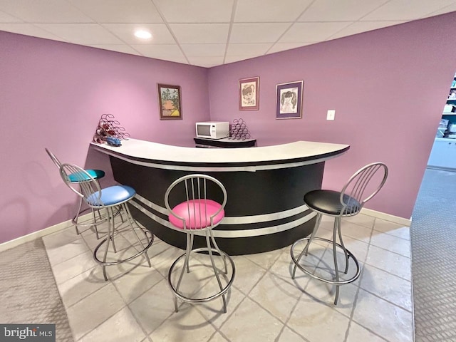52 Dalton Way, Southampton, PA 18966 - indoor dry bar featuring white microwave, a paneled ceiling, baseboards, tile patterned flooring, and recessed lighting