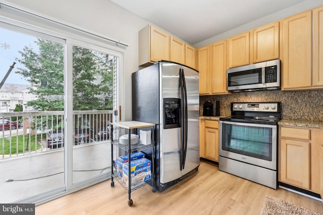 42397 Goldenseal Sq, Brambleton, VA 20148 - kitchen featuring appliances with stainless steel finishes, light brown cabinetry, and light wood finished floors