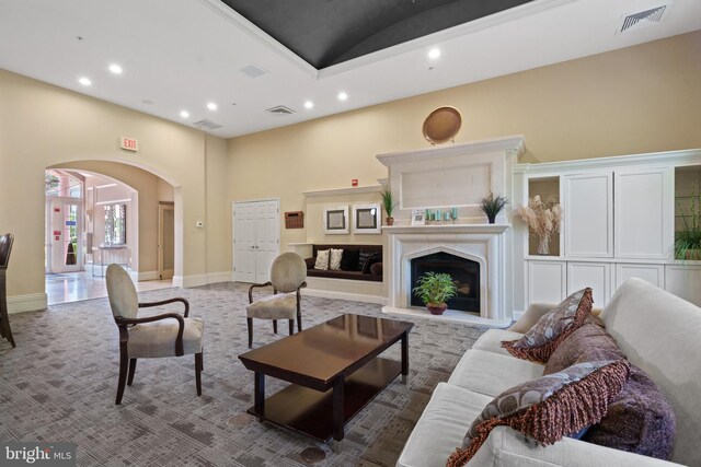 42397 Goldenseal Sq, Brambleton, VA 20148 - living room featuring arched walkways, recessed lighting, a high ceiling, carpet flooring, and baseboards