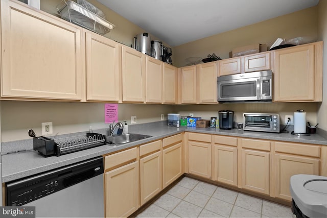 42397 Goldenseal Sq, Brambleton, VA 20148 - kitchen featuring appliances with stainless steel finishes, a sink, light brown cabinetry, and light tile patterned floors