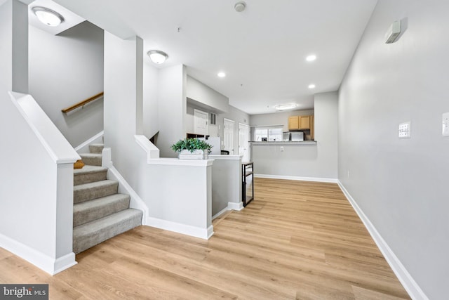 42397 Goldenseal Sq, Brambleton, VA 20148 - hallway with light wood finished floors, recessed lighting, baseboards, and stairs