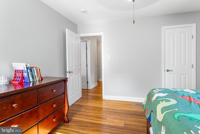 bedroom with hardwood / wood-style floors and baseboards