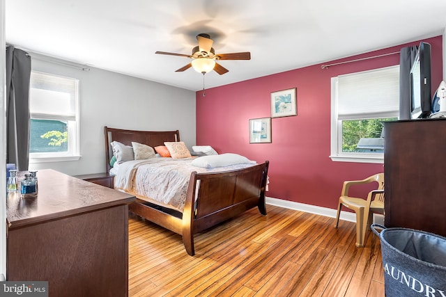 bedroom featuring light wood-style floors, ceiling fan, and baseboards