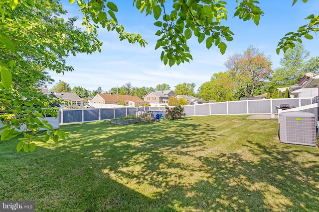 view of yard featuring a residential view and central air condition unit