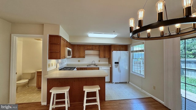 208 Eastern Ave, Annapolis, MD 21403 - kitchen with white appliances, open shelves, light wood-style flooring, light countertops, and healthy amount of natural light