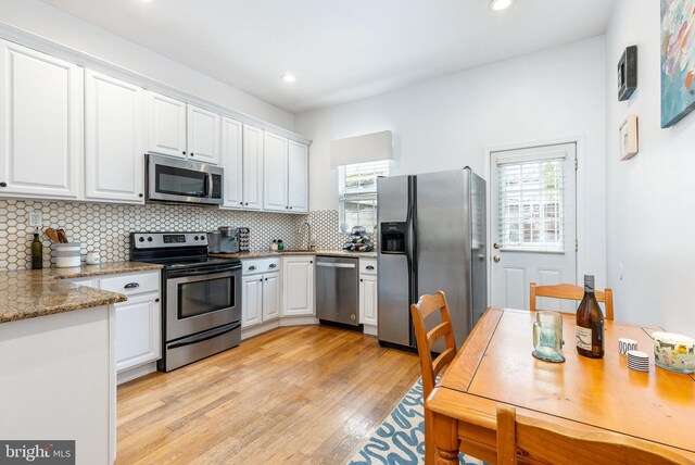 2113 Montrose St, Philadelphia, PA 19146 - kitchen featuring appliances with stainless steel finishes, plenty of natural light, white cabinets, and recessed lighting