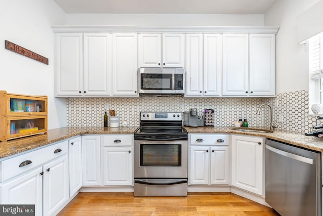 2113 Montrose St, Philadelphia, PA 19146 - kitchen featuring stainless steel appliances, white cabinets, a sink, and backsplash