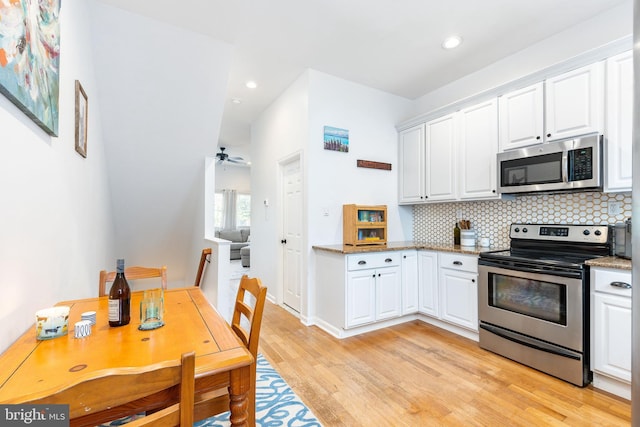 2113 Montrose St, Philadelphia, PA 19146 - kitchen with stainless steel appliances, light wood-type flooring, white cabinets, and recessed lighting