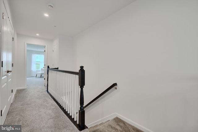 staircase with carpet floors, baseboards, and recessed lighting