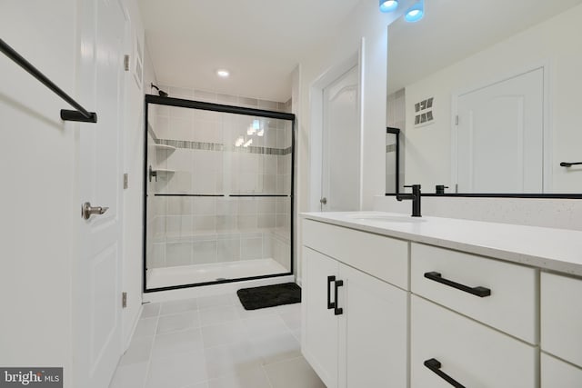 bathroom featuring a stall shower, tile patterned floors, vanity, and recessed lighting