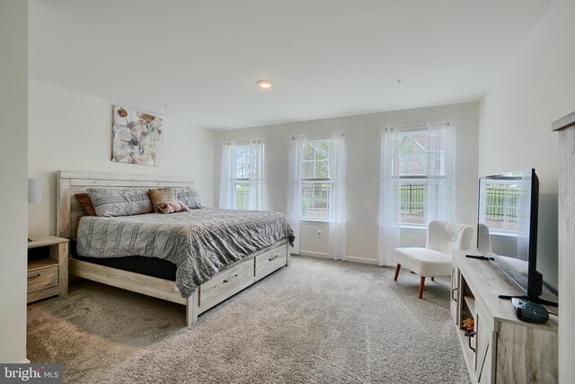 carpeted bedroom featuring baseboards