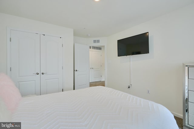 bedroom with a closet and baseboards