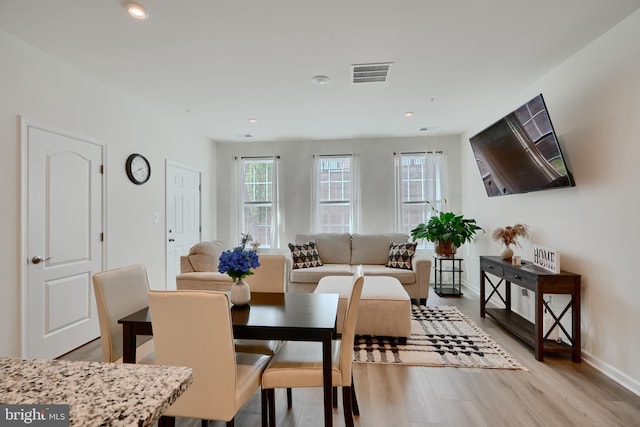 dining area featuring light wood finished floors, baseboards, and recessed lighting