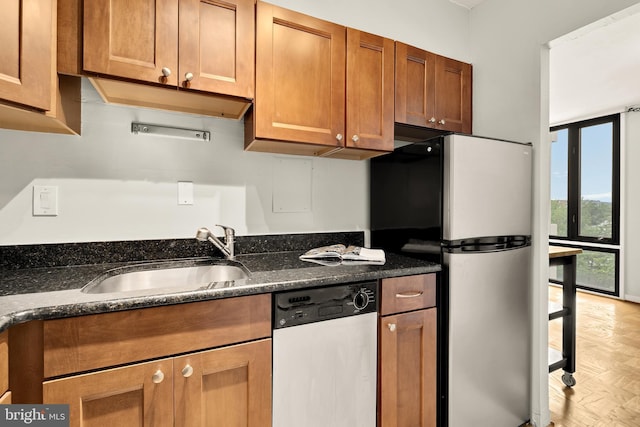 1245 4th St SW Unit E511, Washington, DC 20024 - kitchen with appliances with stainless steel finishes, brown cabinets, and dark stone counters