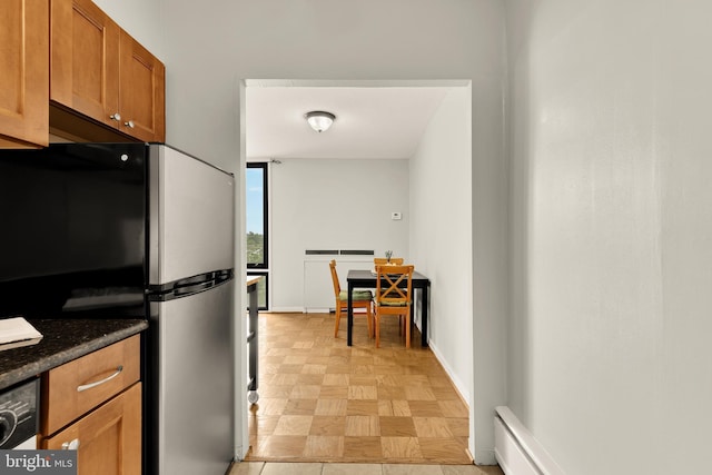 1245 4th St SW Unit E511, Washington, DC 20024 - kitchen with freestanding refrigerator and brown cabinetry