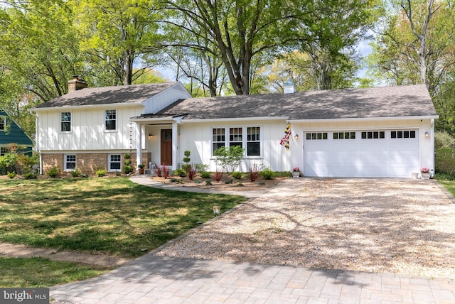 8 Romar Dr, Annapolis, MD 21403 - split level home with a chimney, driveway, a garage, a front lawn, and board and batten siding