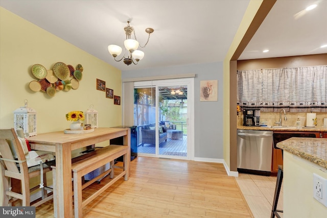 dining area featuring a chandelier, light wood finished floors, recessed lighting, and baseboards