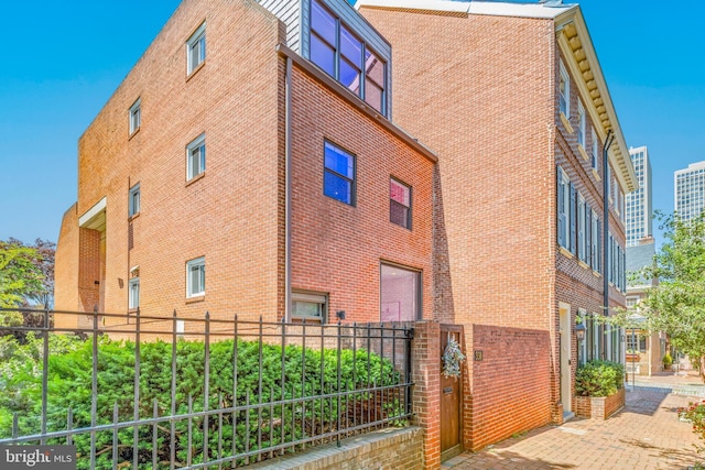 view of building exterior with fence