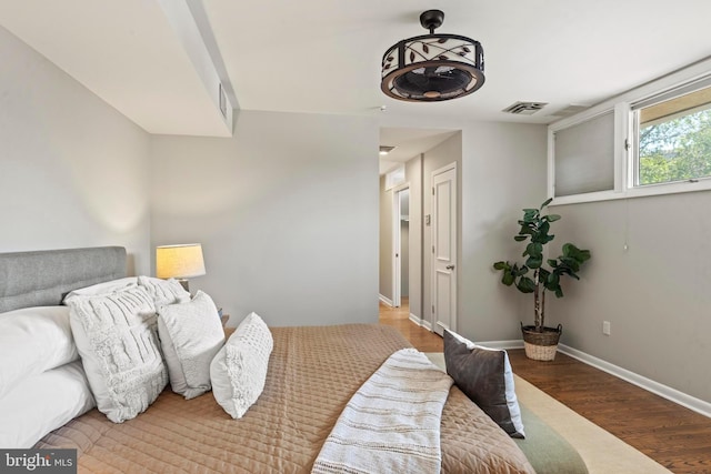bedroom featuring wood finished floors and baseboards