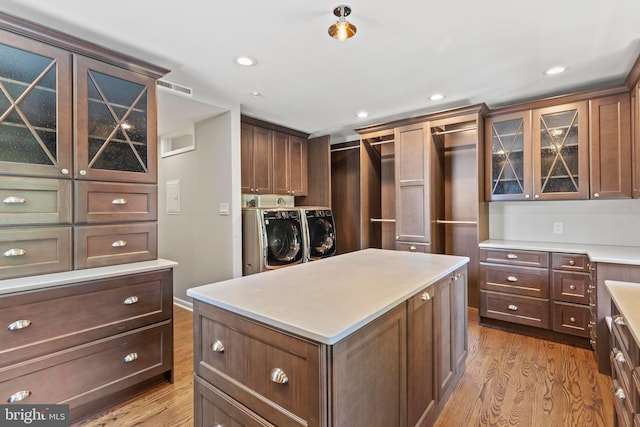 walk in closet featuring washer and clothes dryer and wood finished floors