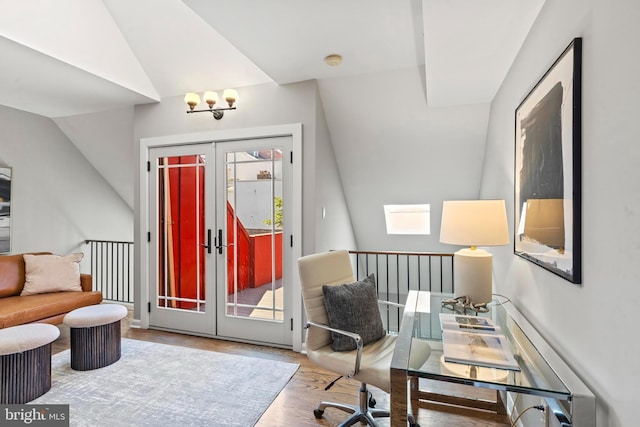 office area featuring wood finished floors, french doors, lofted ceiling, and a skylight