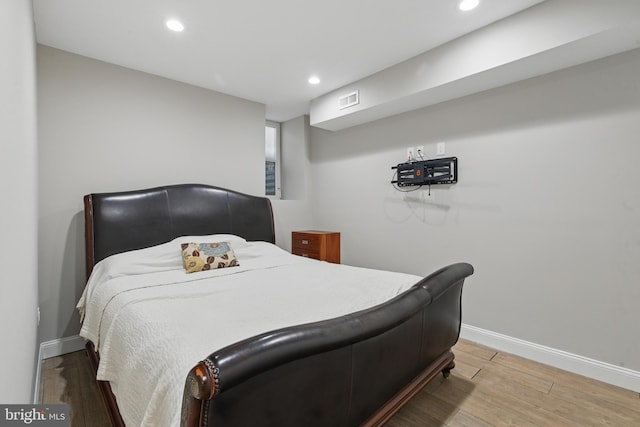 bedroom with light wood-type flooring, recessed lighting, and baseboards