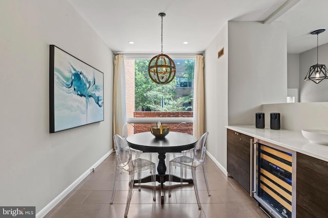 dining area with wine cooler, a chandelier, tile patterned flooring, baseboards, and recessed lighting