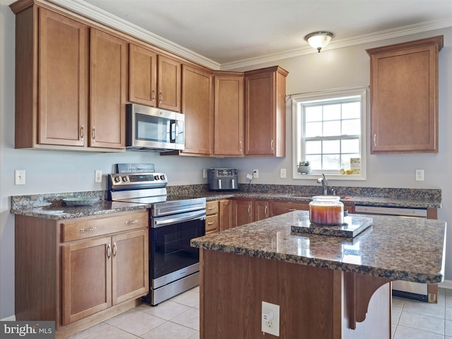 67 Tinning Ct, Hedgesville, WV 25427 - kitchen featuring appliances with stainless steel finishes, a sink, light tile patterned floors, dark stone counters, and ornamental molding