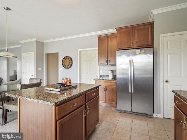 67 Tinning Ct, Hedgesville, WV 25427 - kitchen with freestanding refrigerator, crown molding, light tile patterned floors, dark stone countertops, and a center island