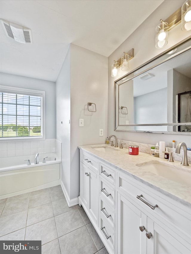 67 Tinning Ct, Hedgesville, WV 25427 - bathroom featuring tile patterned floors, double vanity, a garden tub, and baseboards