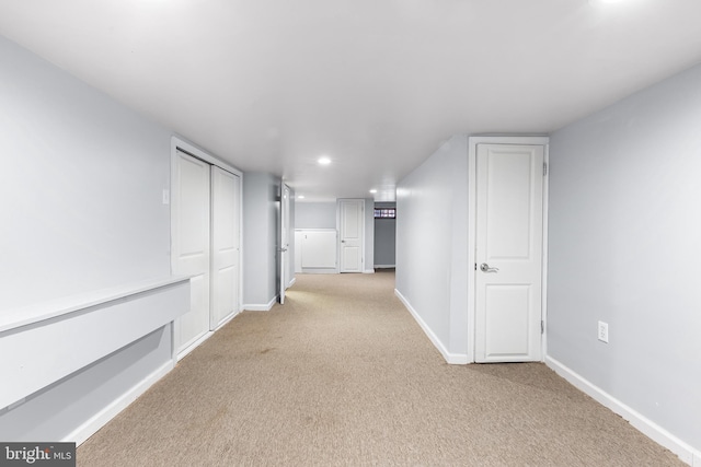 corridor featuring carpet floors, baseboards, and recessed lighting