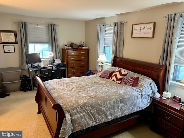 bedroom featuring light carpet