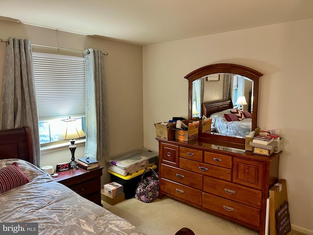 bedroom featuring arched walkways and light colored carpet